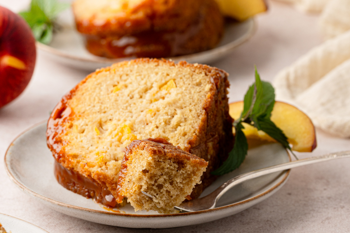 Brown sugar peach Bundt cake topped with bourbon caramel and filled with fresh peaches. Brown sugar peach Bundt cake topped with bourbon caramel and filled with fresh peaches.