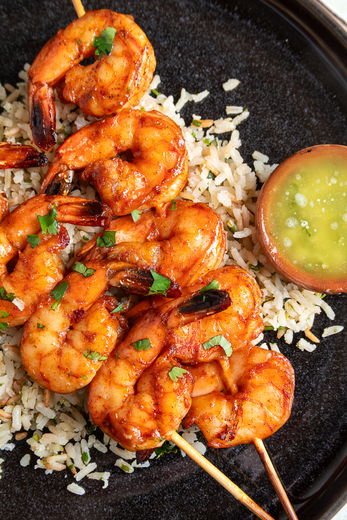 Chipotle honey grilled shrimp skewers served with cilantro lime rice and garlic lime butter