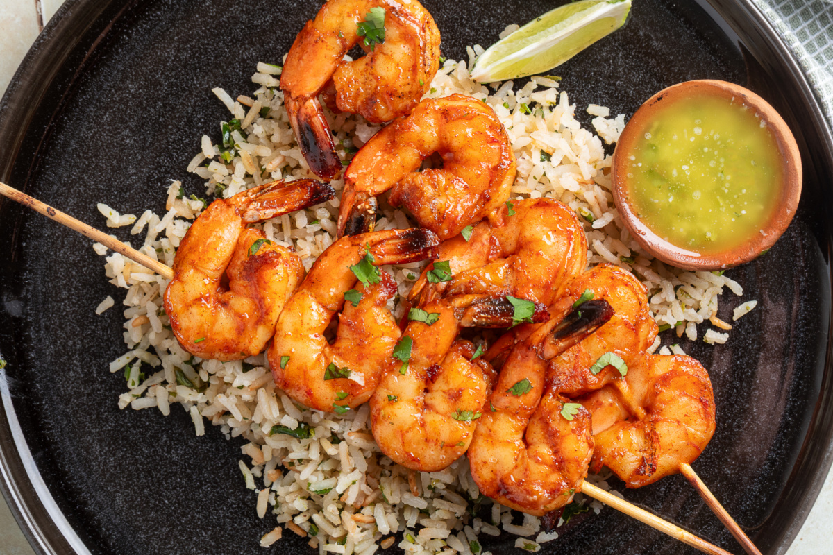 Chipotle honey grilled shrimp skewers served over cilantro lime rice with garlic lime butter
