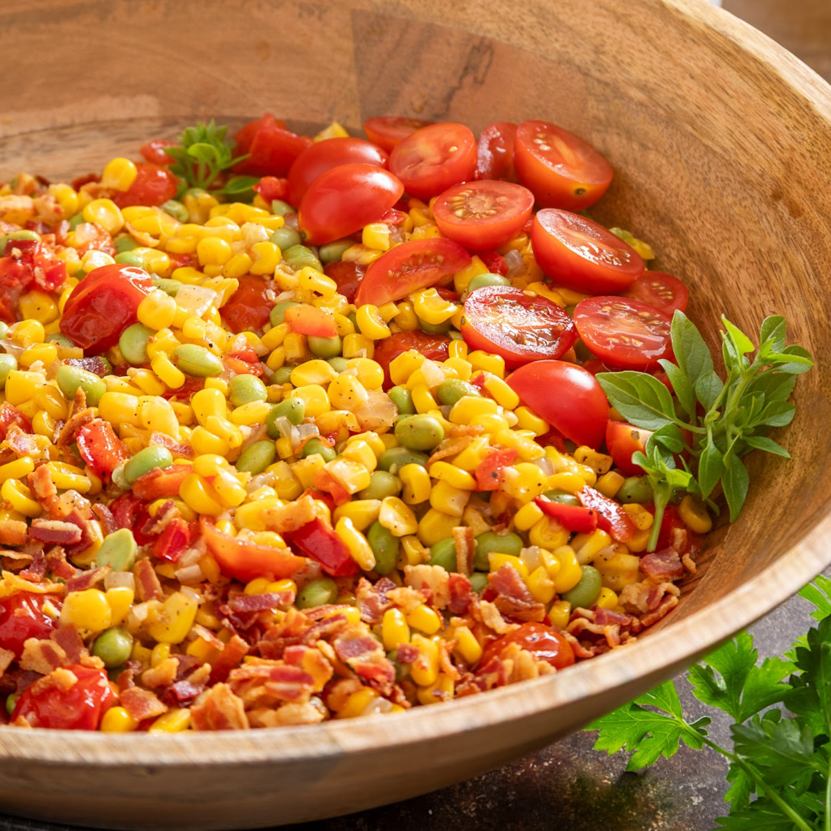 Corn Succotash made with sweet corn, edamame, bacon, peppers, onions, and tomatoes