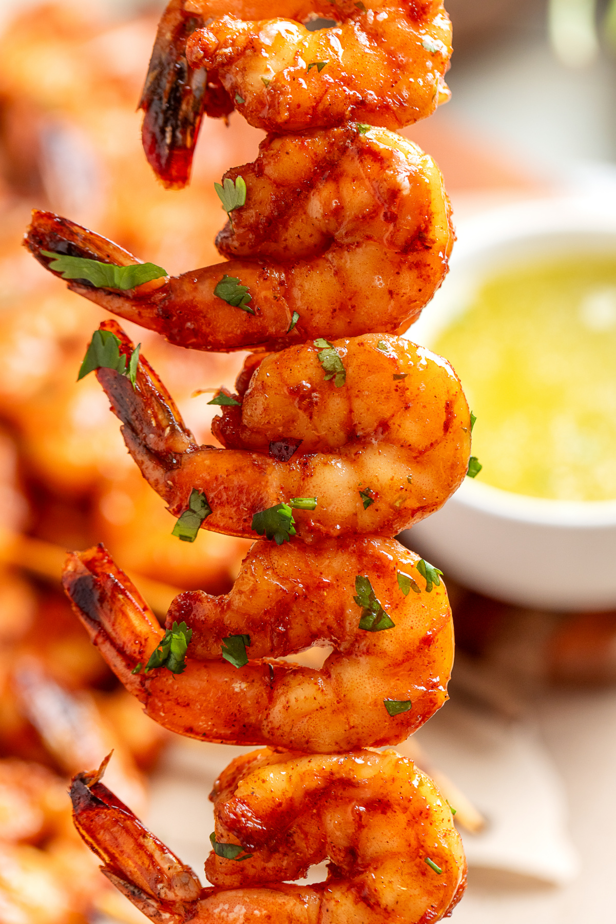 Close-up of a grilled shrimp skewer with chipotle honey glaze and garlic lime butter