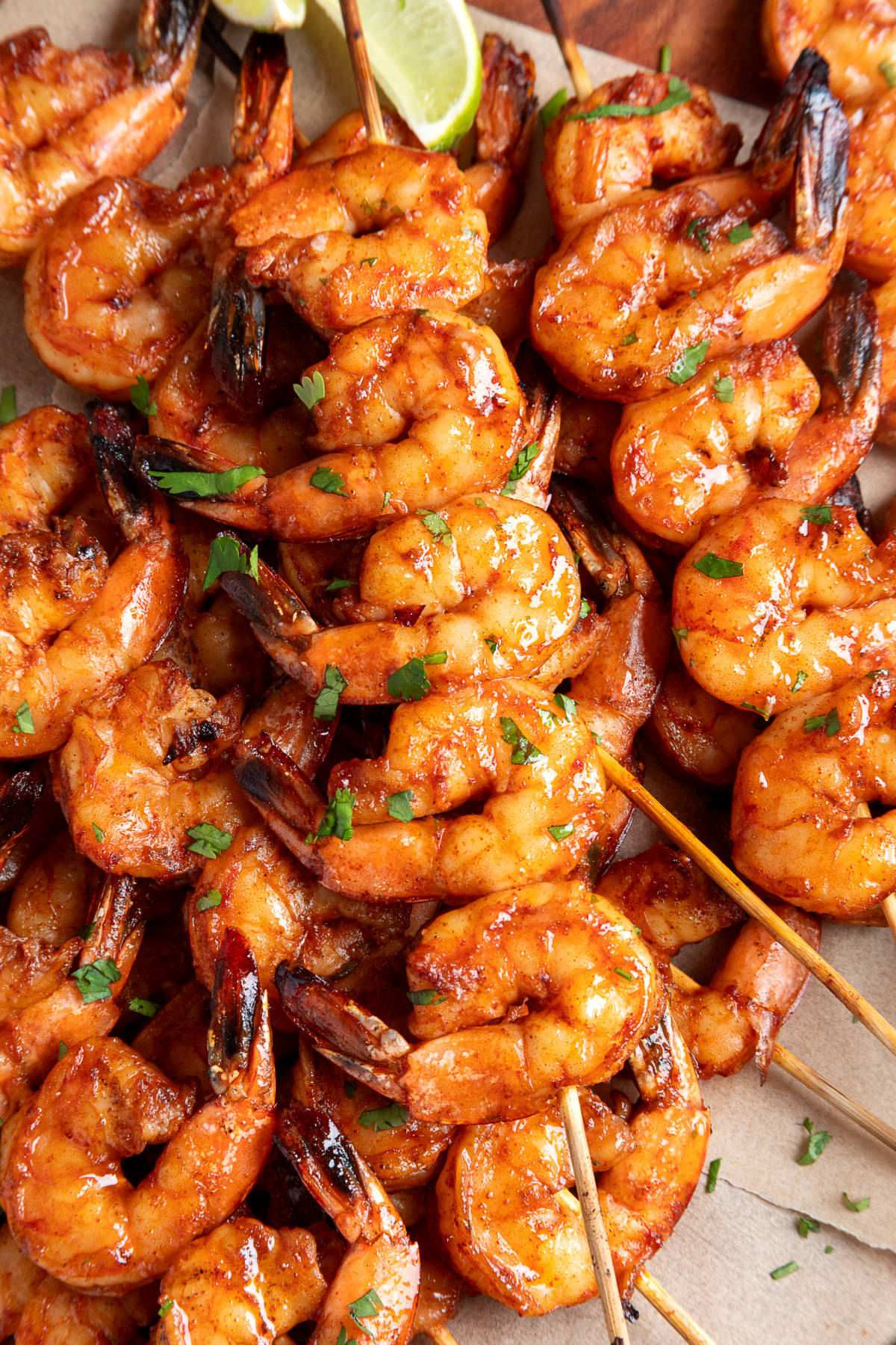 Platter of grilled shrimp skewers with chipotle honey glaze and fresh cilantro