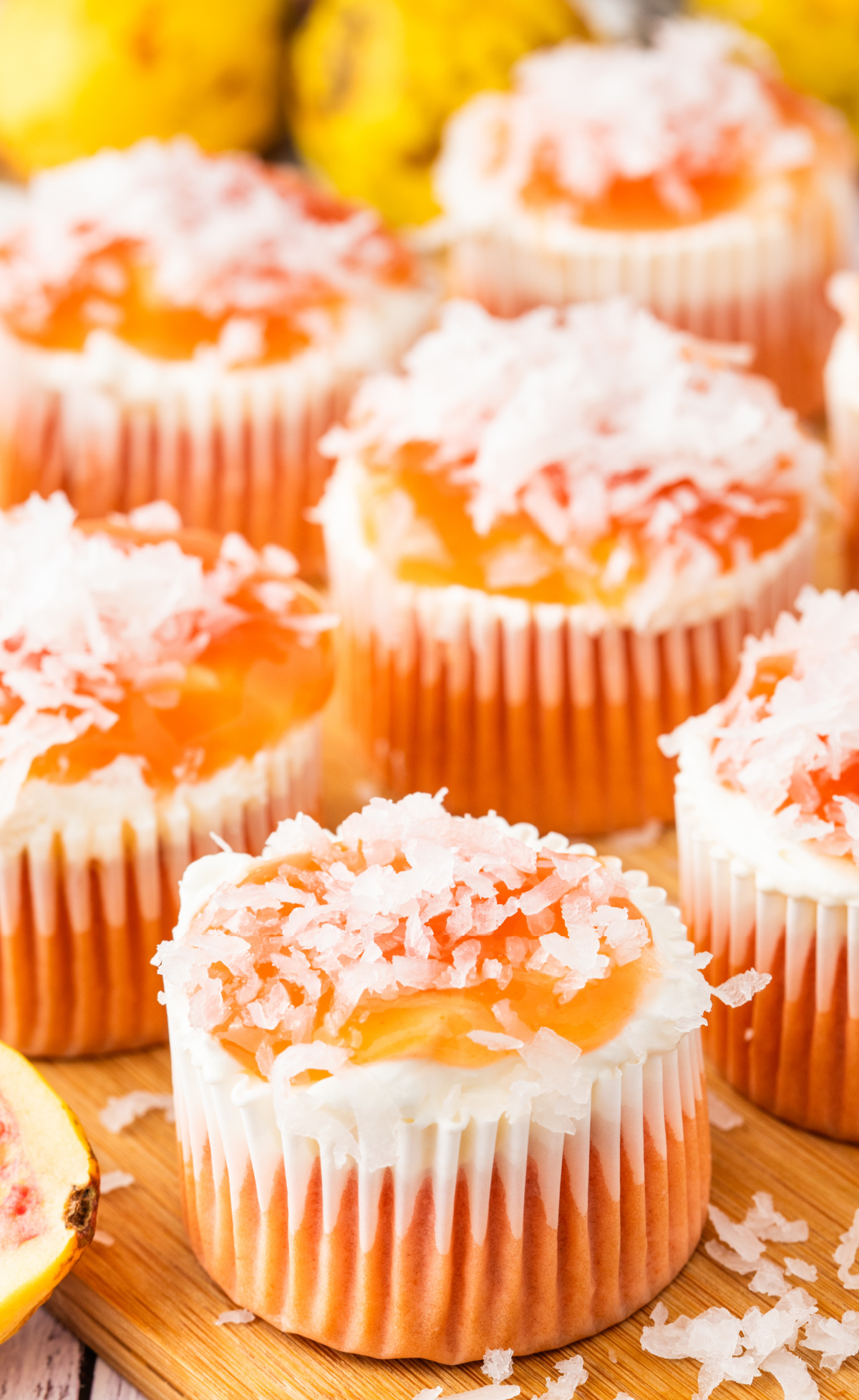 Guava glazed cream cheese cupcakes topped with guava glaze and shredded coconut
