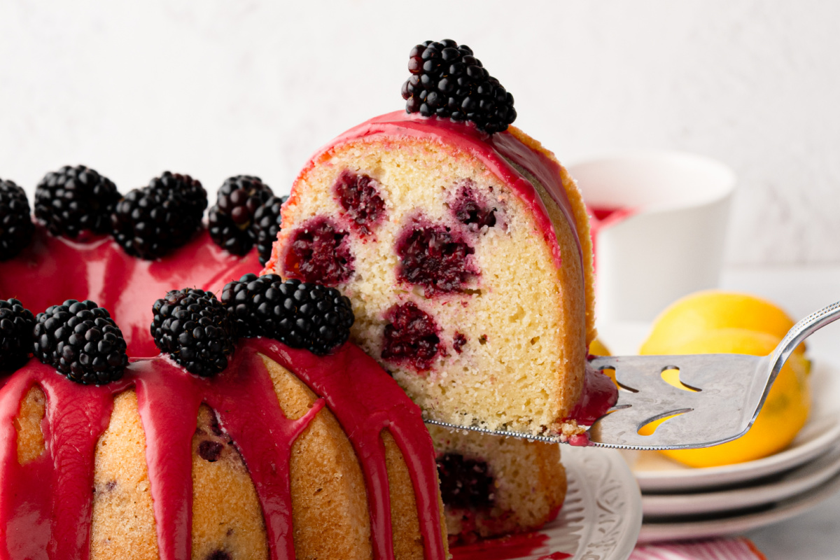 A slice of lemon blackberry Bundt cake with fresh blackberry glaze and blackberry-filled crumb lemon-blackberry-bundt-cake-slice