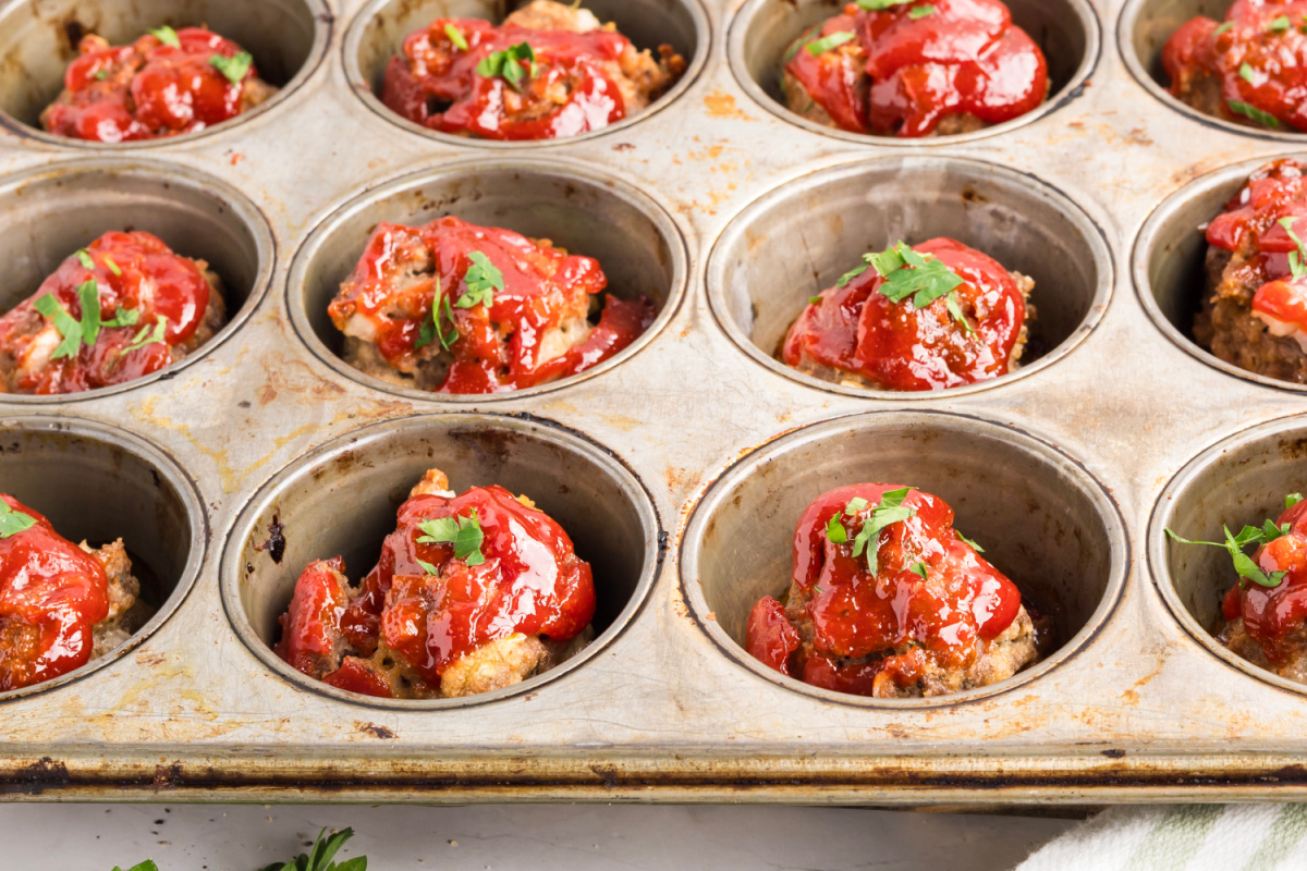 Mini meatloaf recipe fresh from the oven in a muffin tin Mini meatloaf recipe baked in a muffin tin with tomato glaze
