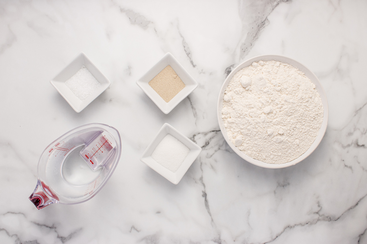 No-Knead Peasant Bread Ingredients Ingredients for no-knead peasant bread including flour, yeast, sugar, salt, and water