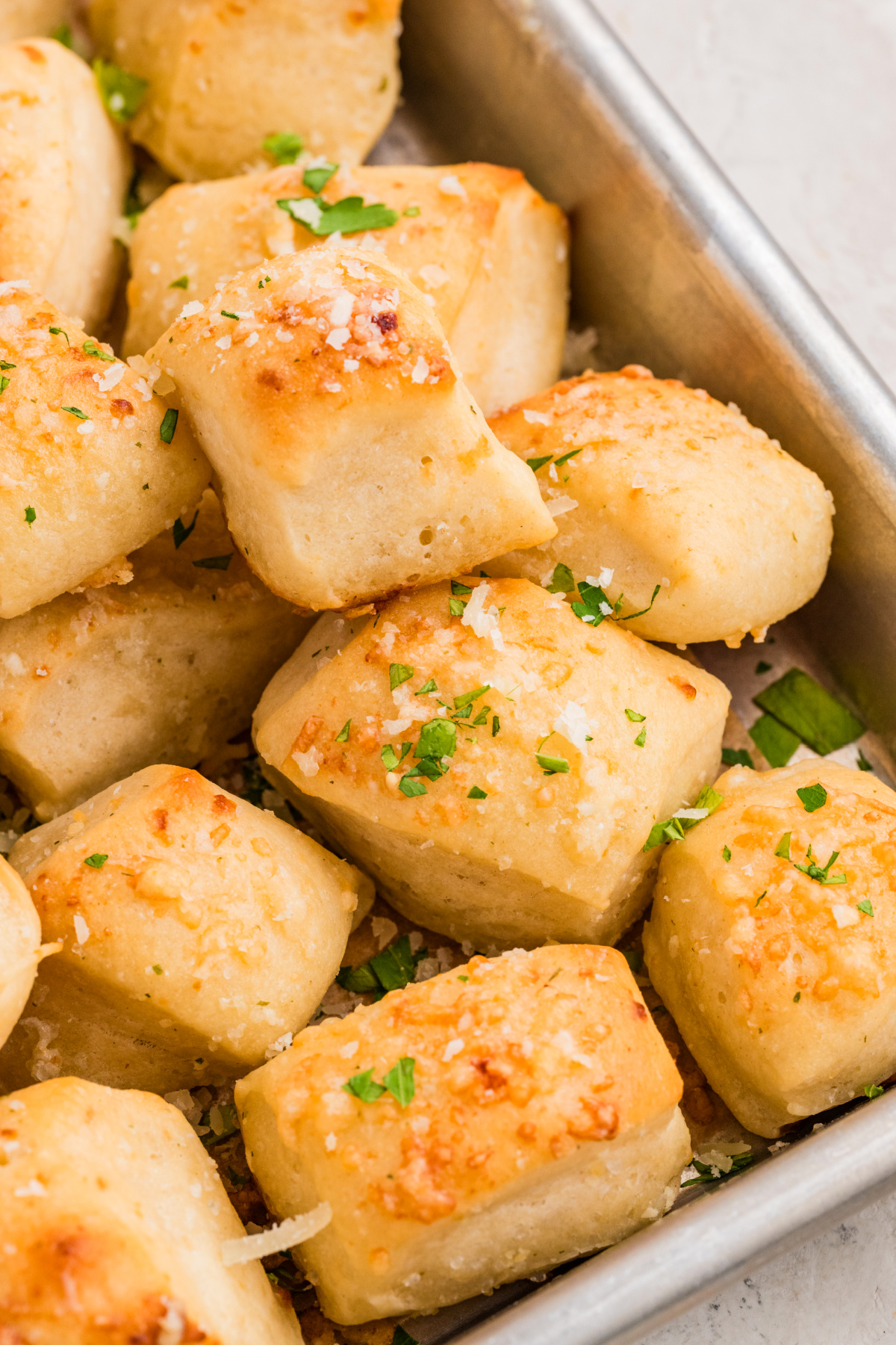 A close-up view of homemade Parmesan bread bites with a soft texture and cheesy topping Close-up of Parmesan bread bites showing their soft interior and golden Parmesan topping