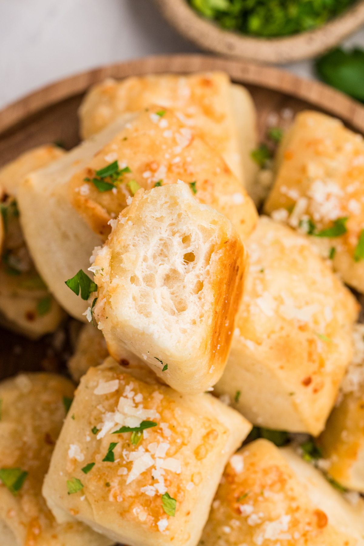 The soft interior of a homemade Parmesan bread bite after baking Parmesan bread bite showing the soft, fluffy interior and golden Parmesan crust
