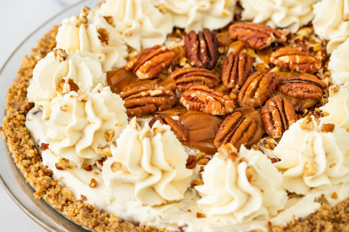 Pecan Cream Pie Recipe Whole pecan cream pie topped with whipped cream, toasted pecans, caramel drizzle, and a pecan crust