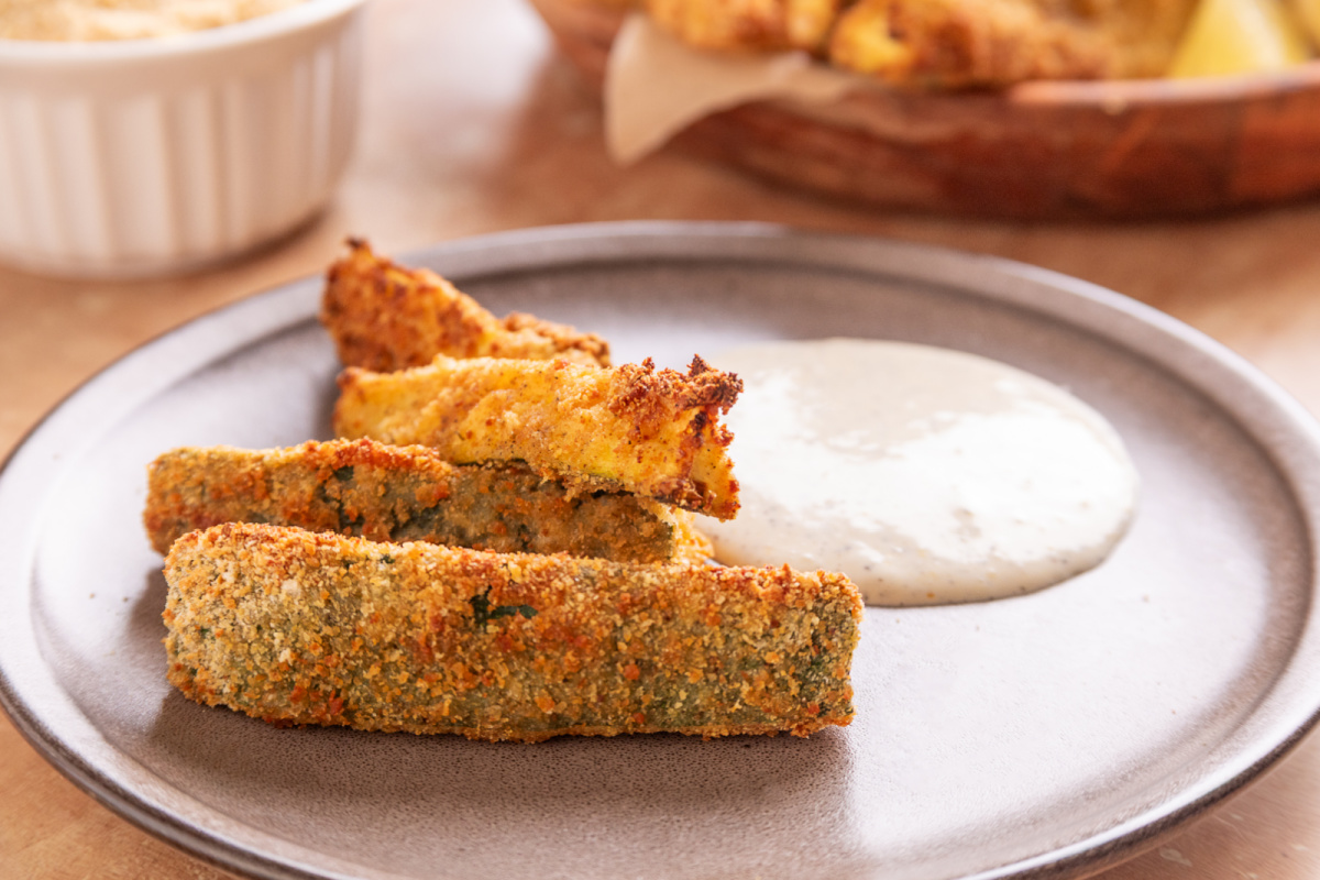 Air Fryer Zucchini Fries with Lemon Garlic Aioli Air Fryer Zucchini Fries served with homemade lemon garlic aioli on a plate.