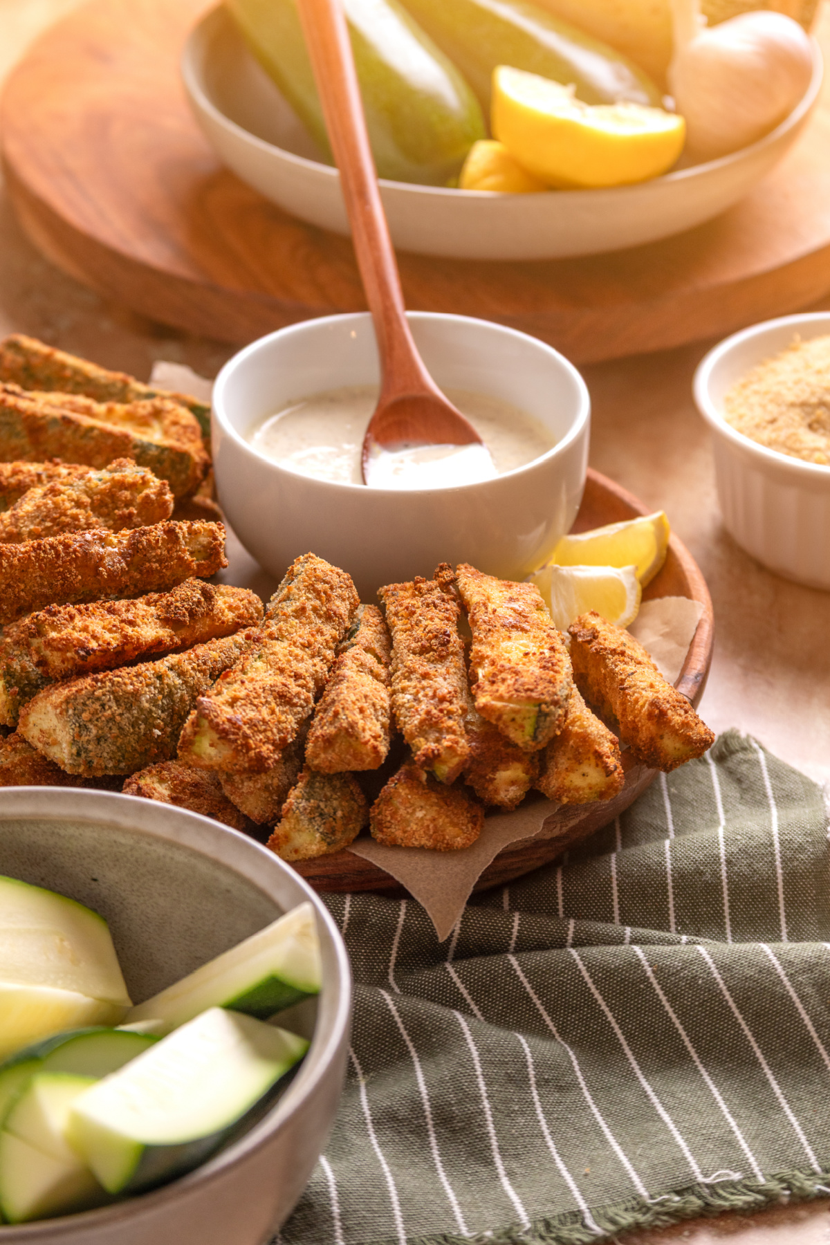 Serving Board of Crispy Zucchini Fries Serving board of crispy zucchini fries with homemade lemon garlic aioli and fresh zucchini.