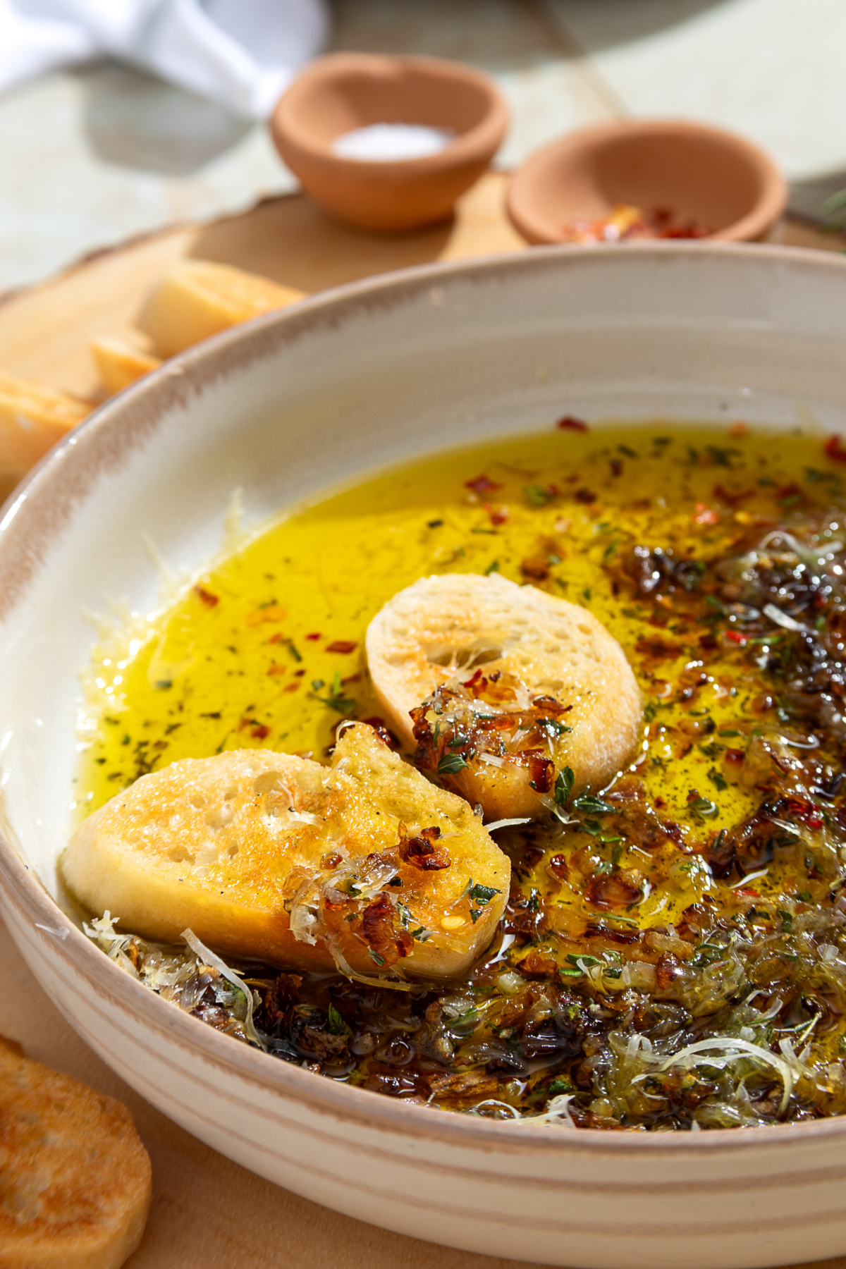 Bread Dipping Oil Bread dipping oil with caramelized shallots, fresh herbs, Parmesan, and toasted bread.