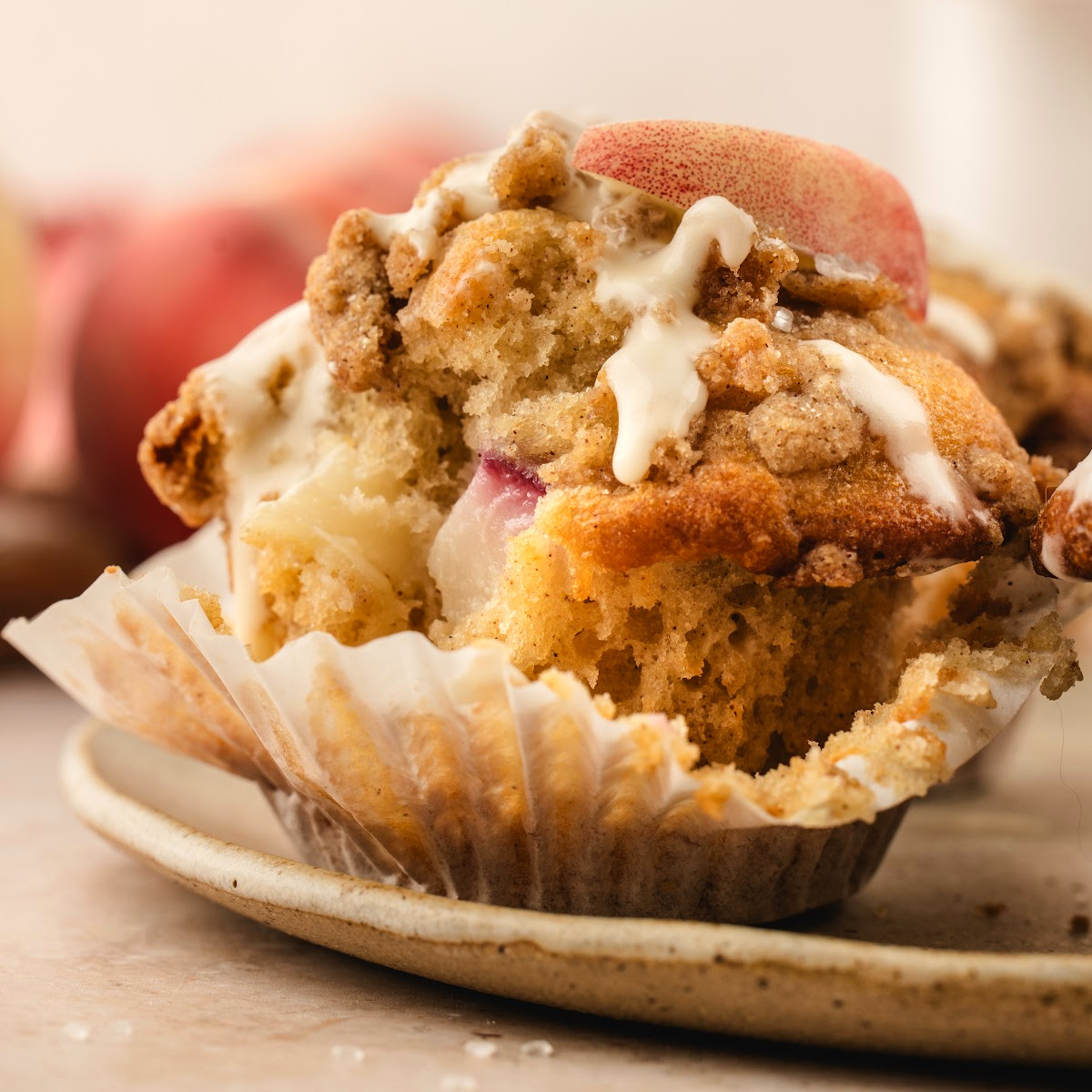 Brown Butter Peach Coffee Cake Muffin with fresh peaches, cinnamon streusel, and vanilla glaze