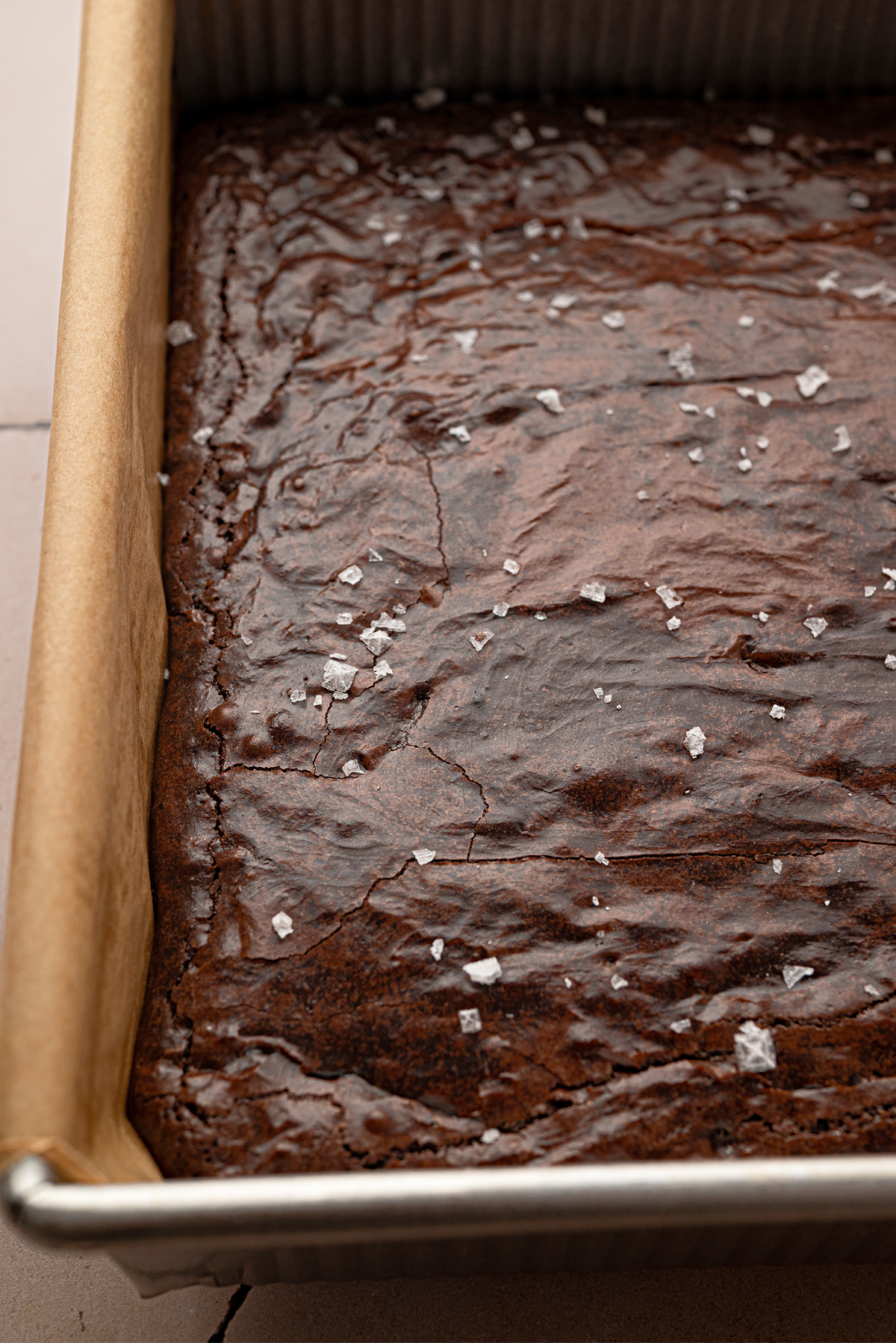 Freshly baked Cabernet Sauvignon Brown Butter Brownies Freshly baked Cabernet Sauvignon brown butter brownies in a parchment-lined baking pan with flaky sea salt.