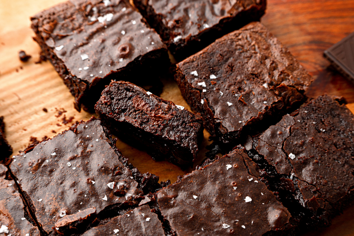 Freshly baked Cabernet Sauvignon Brown Butter Brownies Cabernet Sauvignon brown butter brownies cut into squares in the baking pan with flaky sea salt on top.