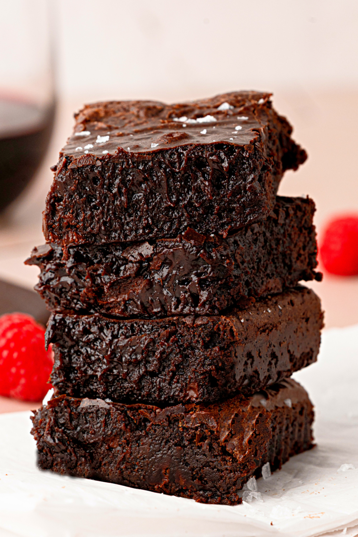 Cabernet Sauvignon Brown Butter Brownies Cabernet Sauvignon brown butter brownies stacked on parchment with flaky sea salt.