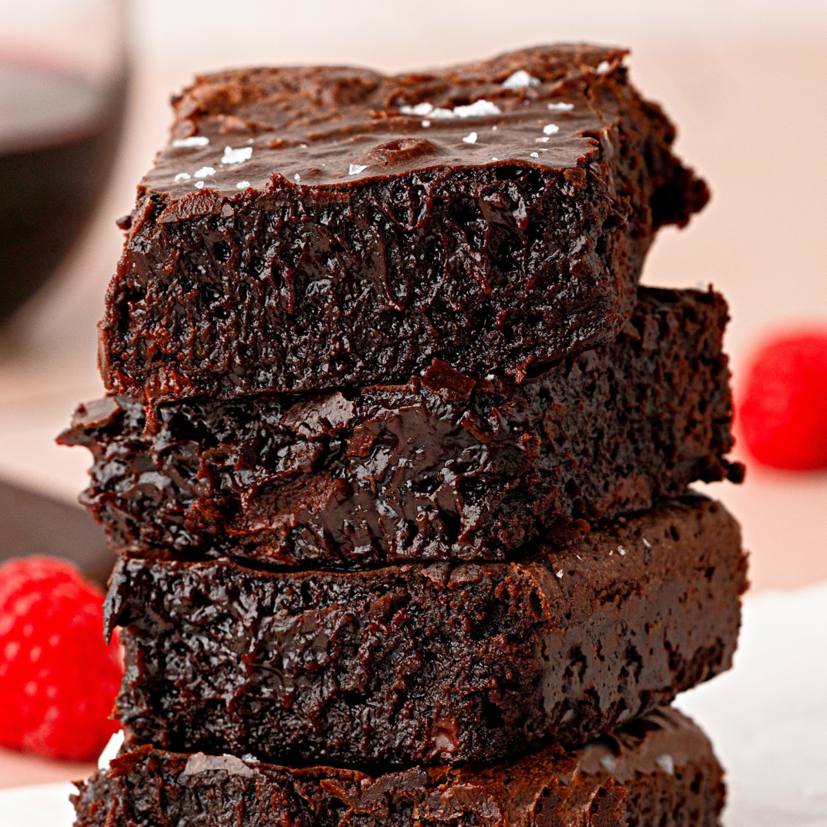 Cabernet Sauvignon brownies stacked to show their rich, fudgy interior with flaky sea salt on top.