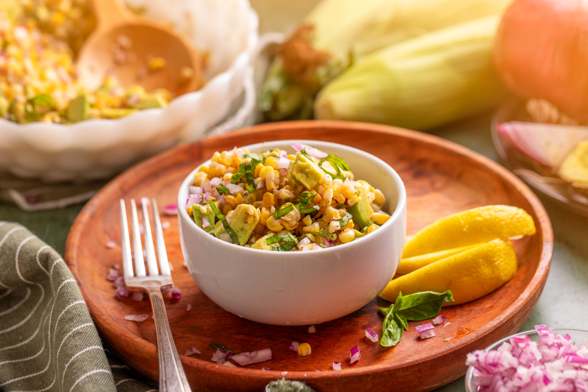 Serving bowl of grilled corn salad with avocado