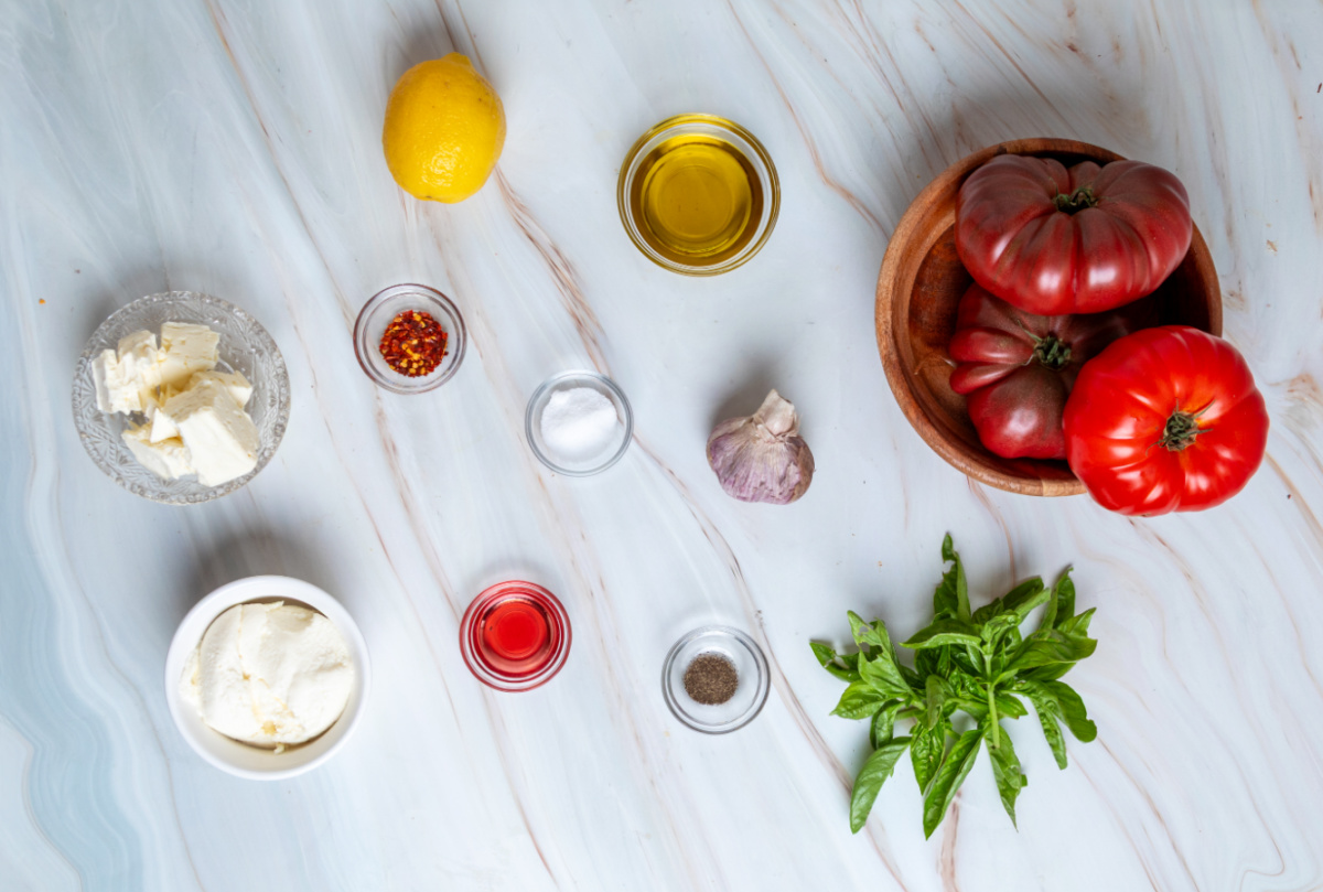 Everything you need to make heirloom tomato salad over whipped ricotta feta starts with ripe tomatoes and a handful of fresh ingredients. heirloom-tomato-salad-over-whipped-ricotta-feta-ingredients