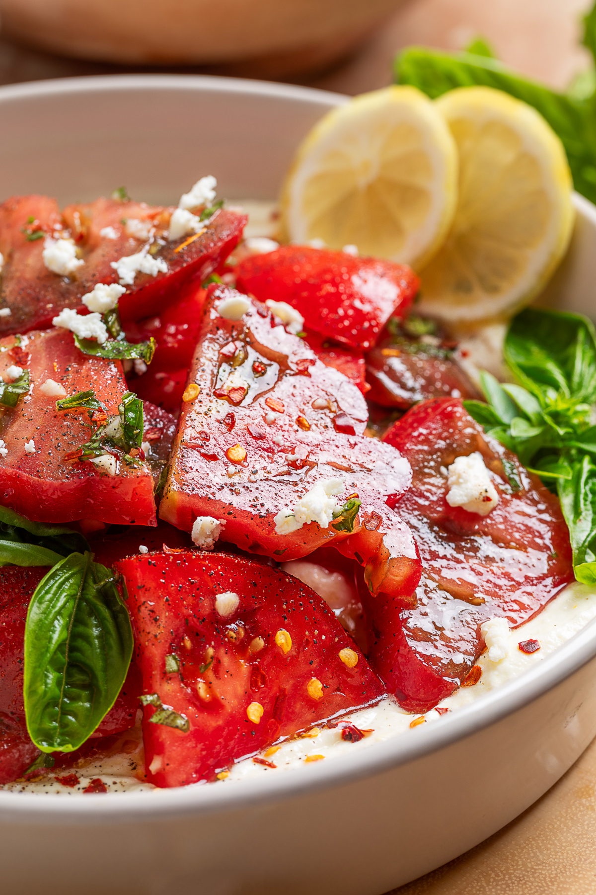 Heirloom tomato salad over whipped ricotta feta lets peak-season tomatoes shine with a creamy ricotta-feta base and fresh basil. Heirloom tomato salad over whipped ricotta feta with fresh basil, lemon, and a simple vinaigrette.