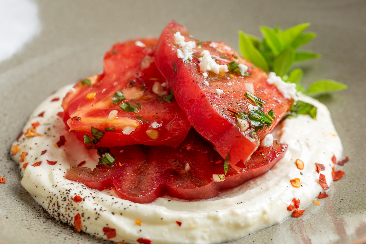 Every bite gets creamy whipped ricotta-feta, juicy heirloom tomatoes, fresh basil, and a little of the lemon vinaigrette. heirloom-tomato-salad-whipped-ricotta-feta-close-up