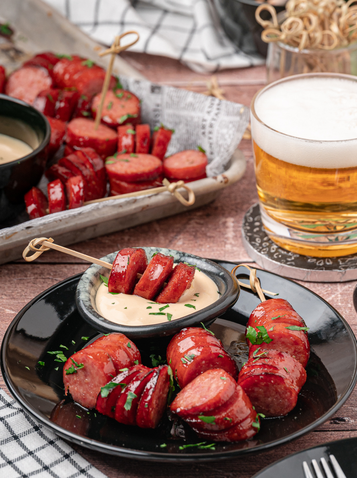 Honey garlic kielbasa bites make an easy appetizer to serve with a cold beer. Honey garlic kielbasa bites served with creamy honey mustard and a cold beer.