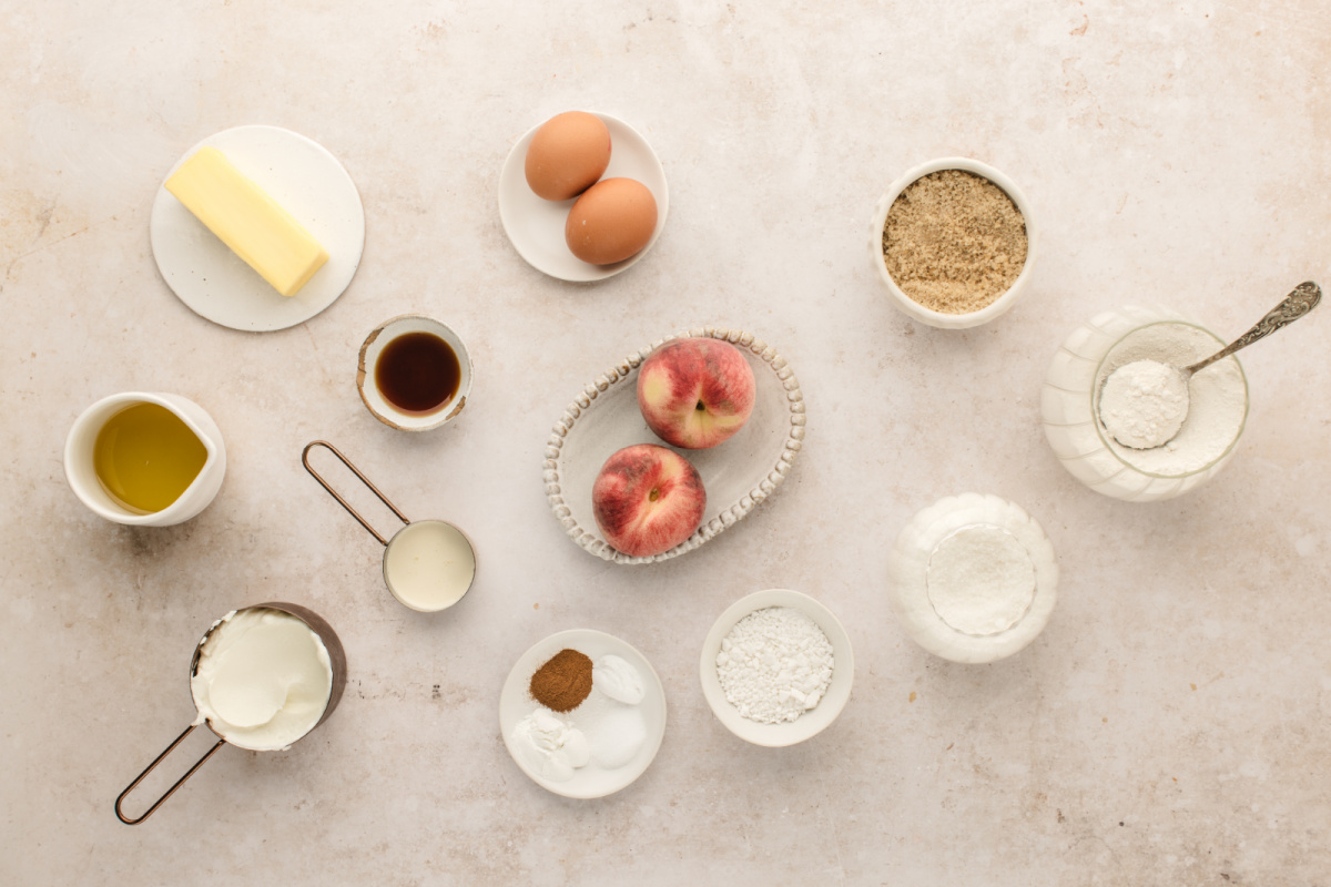 Fresh peaches, Greek yogurt, brown butter, flour, eggs, and ingredients for peach coffee cake muffins