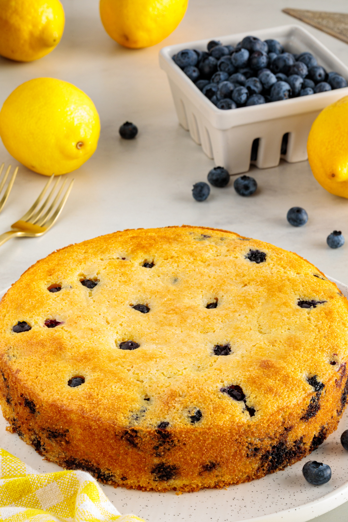 Lemon blueberry cornbread baked with buttermilk, fresh blueberries, and the zest of two lemons. Lemon blueberry cornbread baked until golden brown with fresh blueberries in an 8-inch round pan.