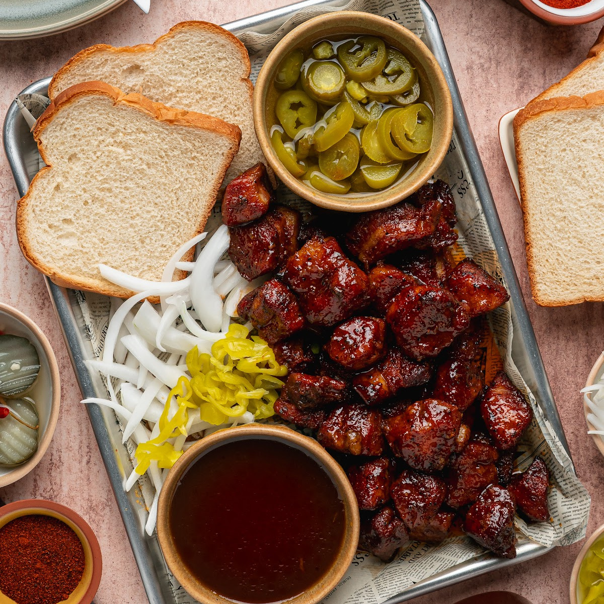 Close-up views of Peach Tea Pork Belly Burnt Ends with a sticky caramelized peach tea glaze.