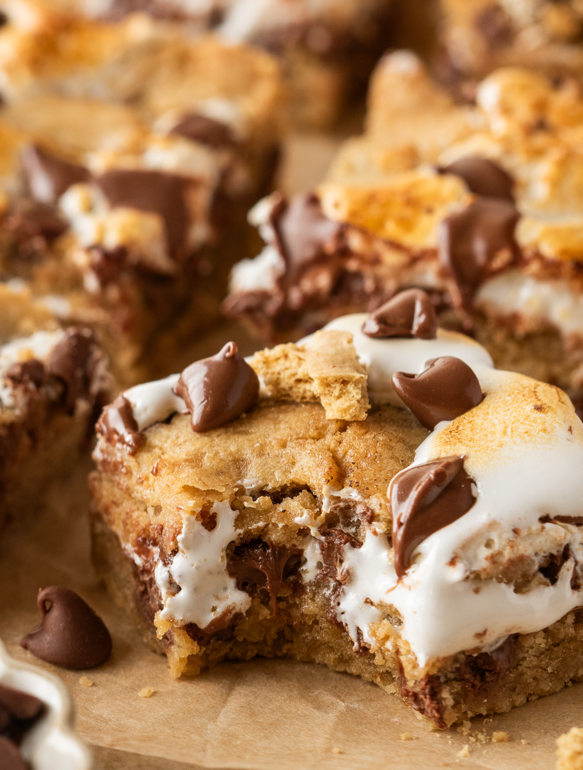 S'mores cookie bars with graham cookie dough, gooey marshmallow creme, and milk chocolate chips.