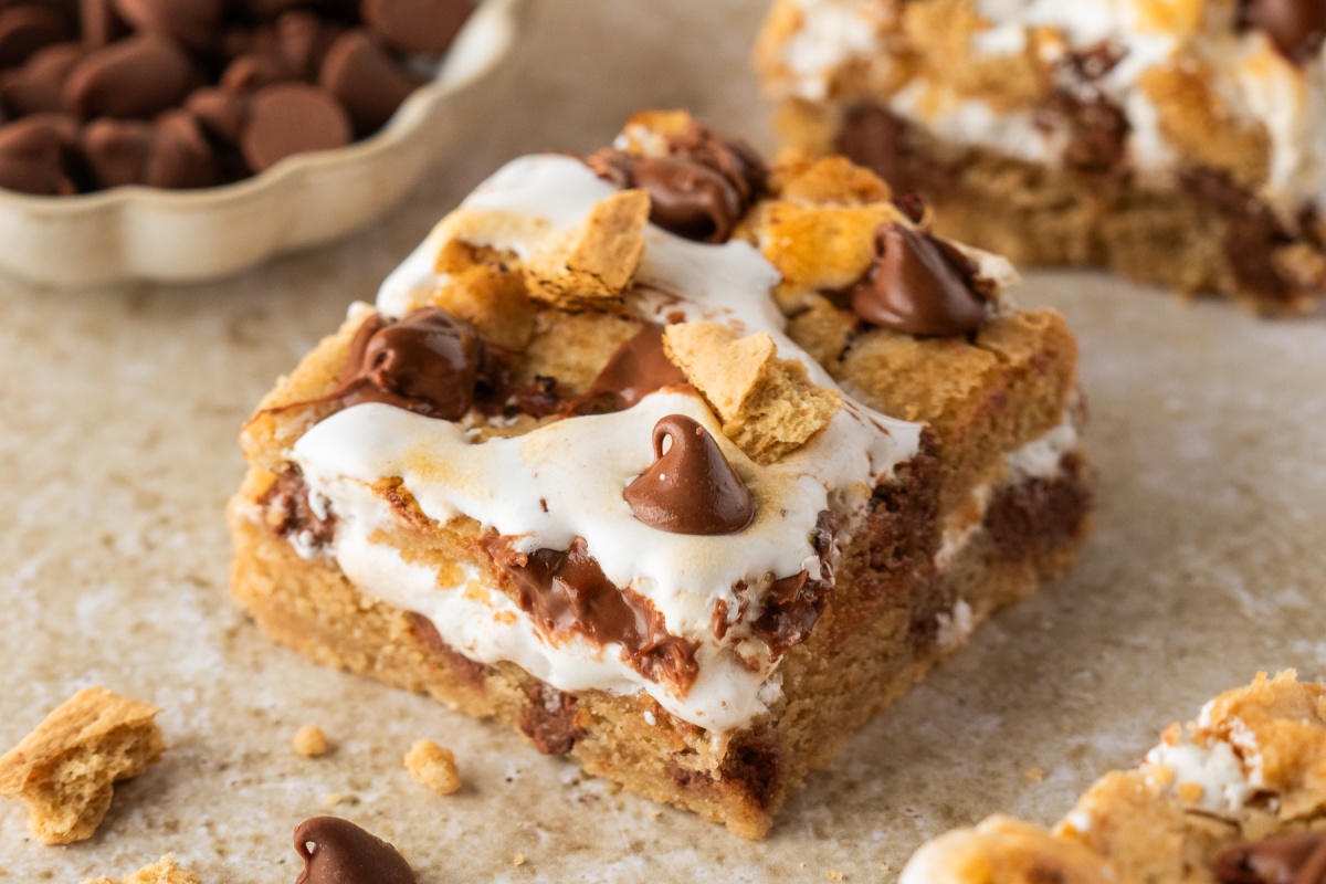 Close-up of s'mores cookie bars with graham cookie dough, toasted marshmallow creme, and milk chocolate.