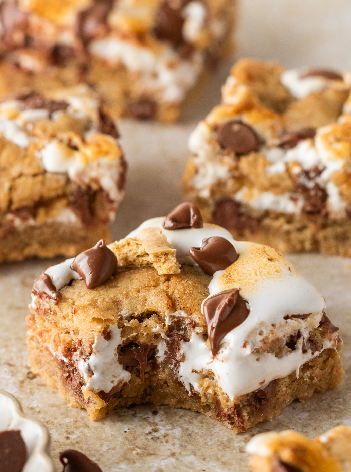 Close-up of s'mores cookie bars showing the gooey marshmallow creme center and milk chocolate inside the graham cookie dough.