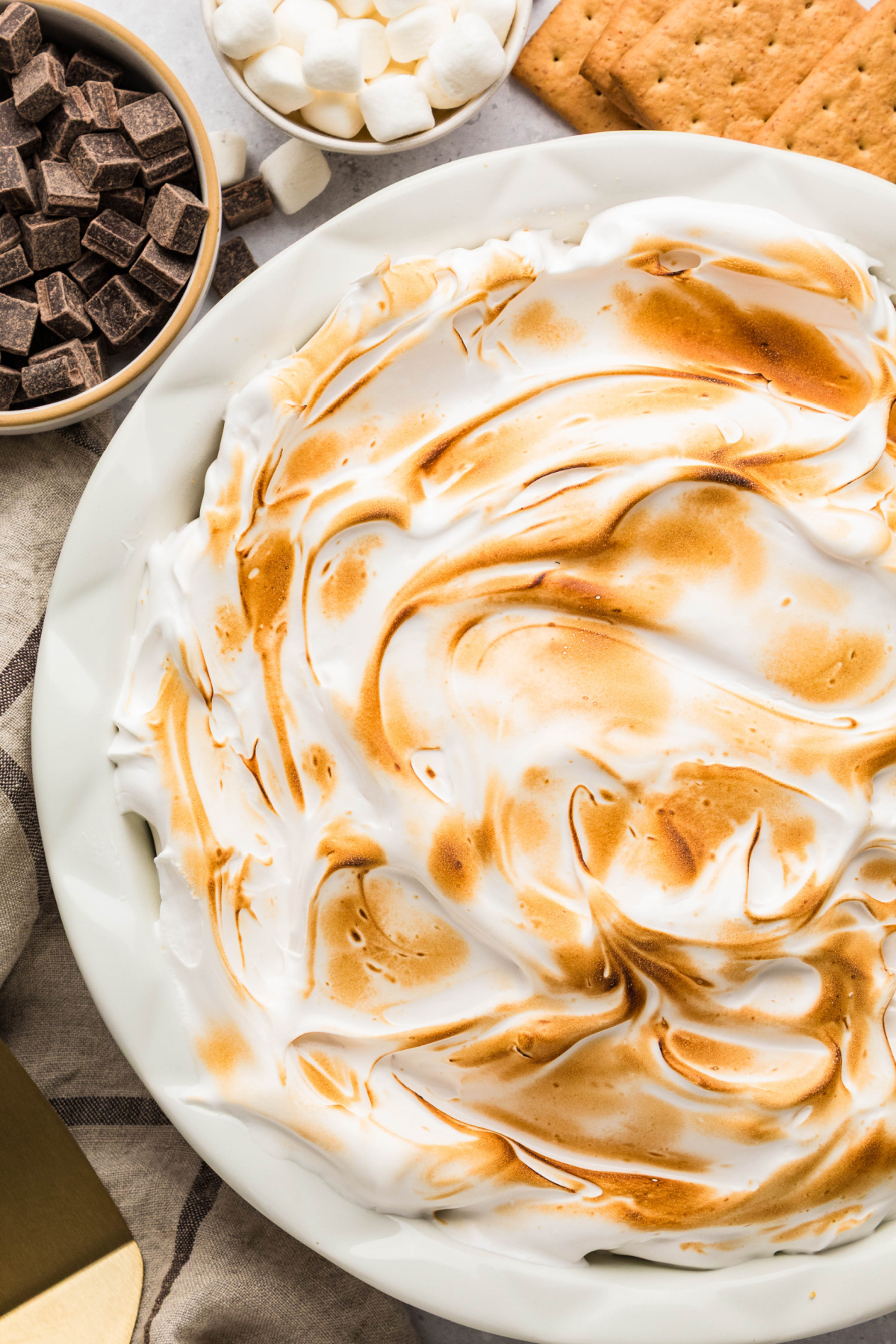 S'mores pie with homemade toasted marshmallow topping over chocolate ganache.
