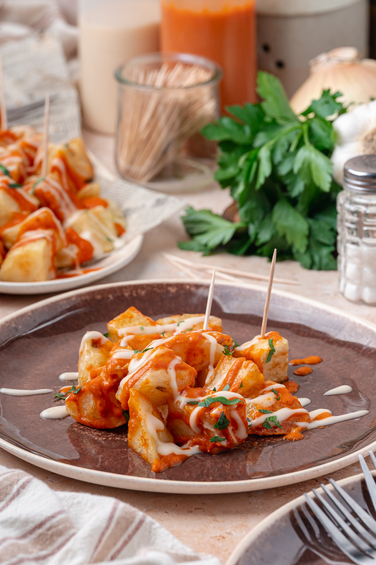Spanish Tapas Potatoes Crispy fried potatoes served with smoky bravas sauce, garlic aioli, and fresh parsley.