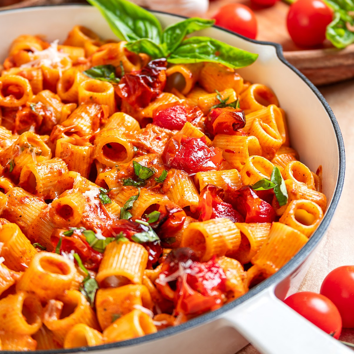 Close-up of spicy roasted tomato vodka pasta with roasted grape tomatoes, creamy sauce, and fresh basil.