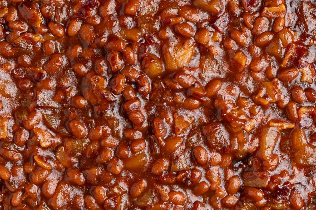 Close-up of apple pie baked beans with pieces of apple and bacon