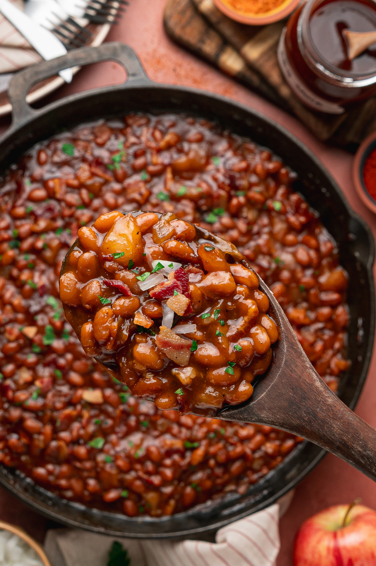 Spoonful of apple pie baked beans with bacon and tender apple pieces