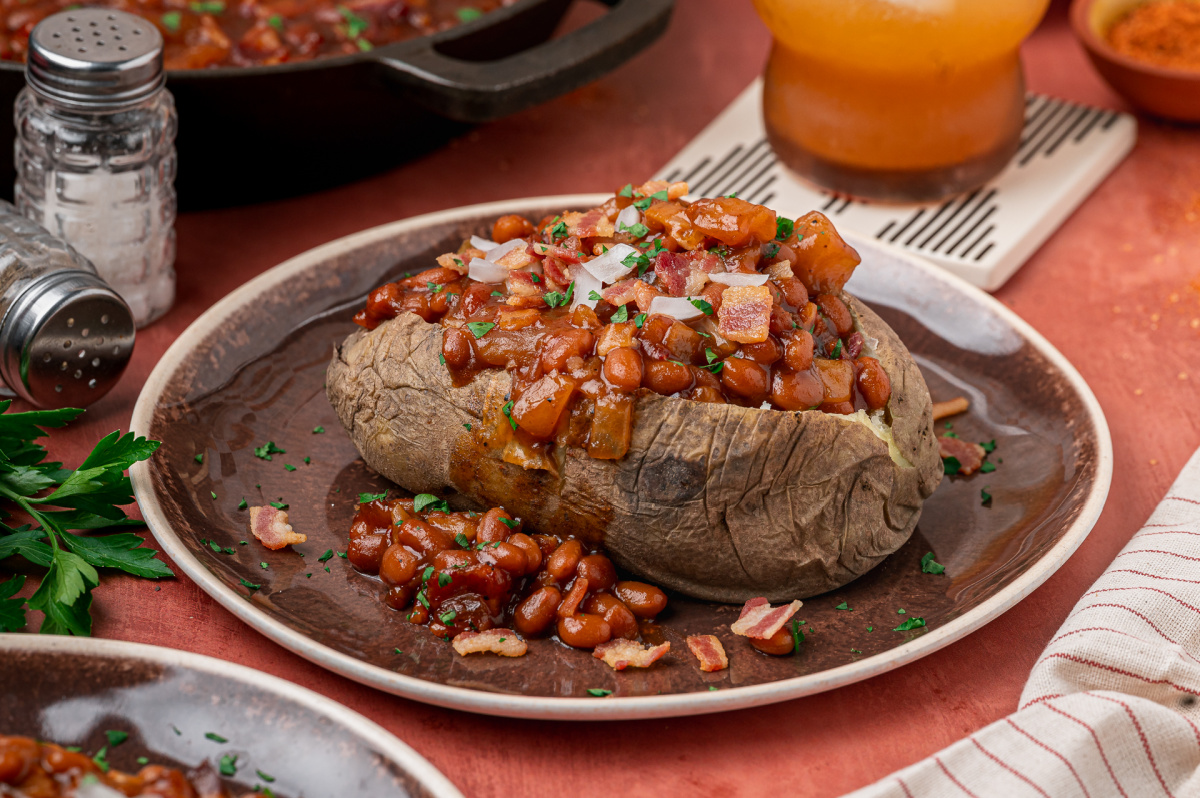 Baked potato topped with smoky baked beans, apple pieces, bacon and diced onion