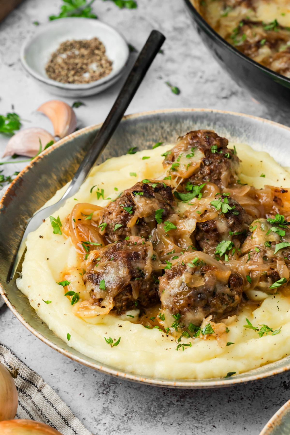 Beef meatballs, caramelized onions and Gruyère served over a generous bed of mashed potatoes. Caramelized onion meatballs with Gruyère and onion sauce over mashed potatoes