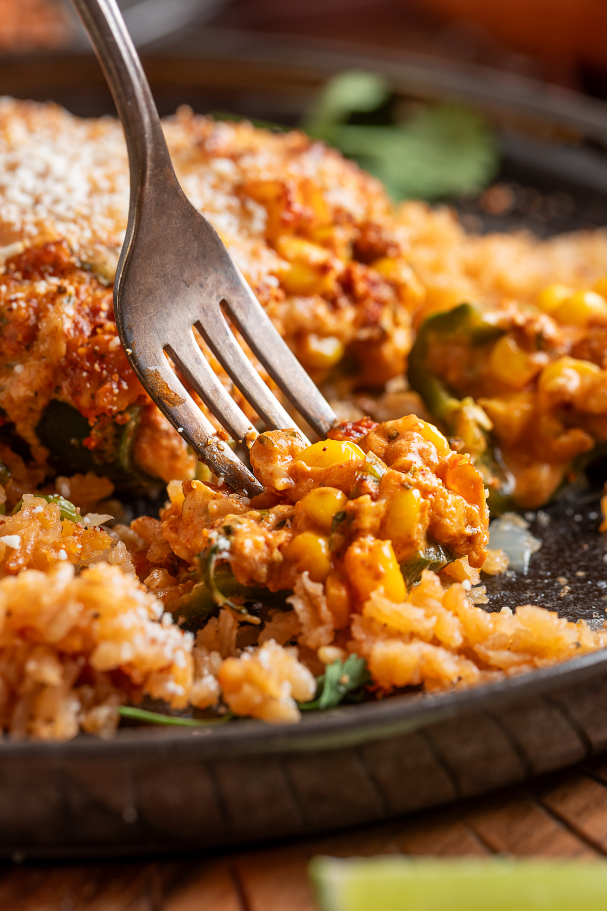 Stuffed poblano pepper cut open with creamy chorizo, corn, jalape&ntilde;o and cheese filling served over rice
