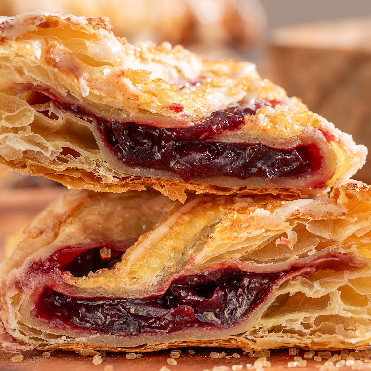 Cherry turnovers with dark cherry filling inside flaky puff pastry