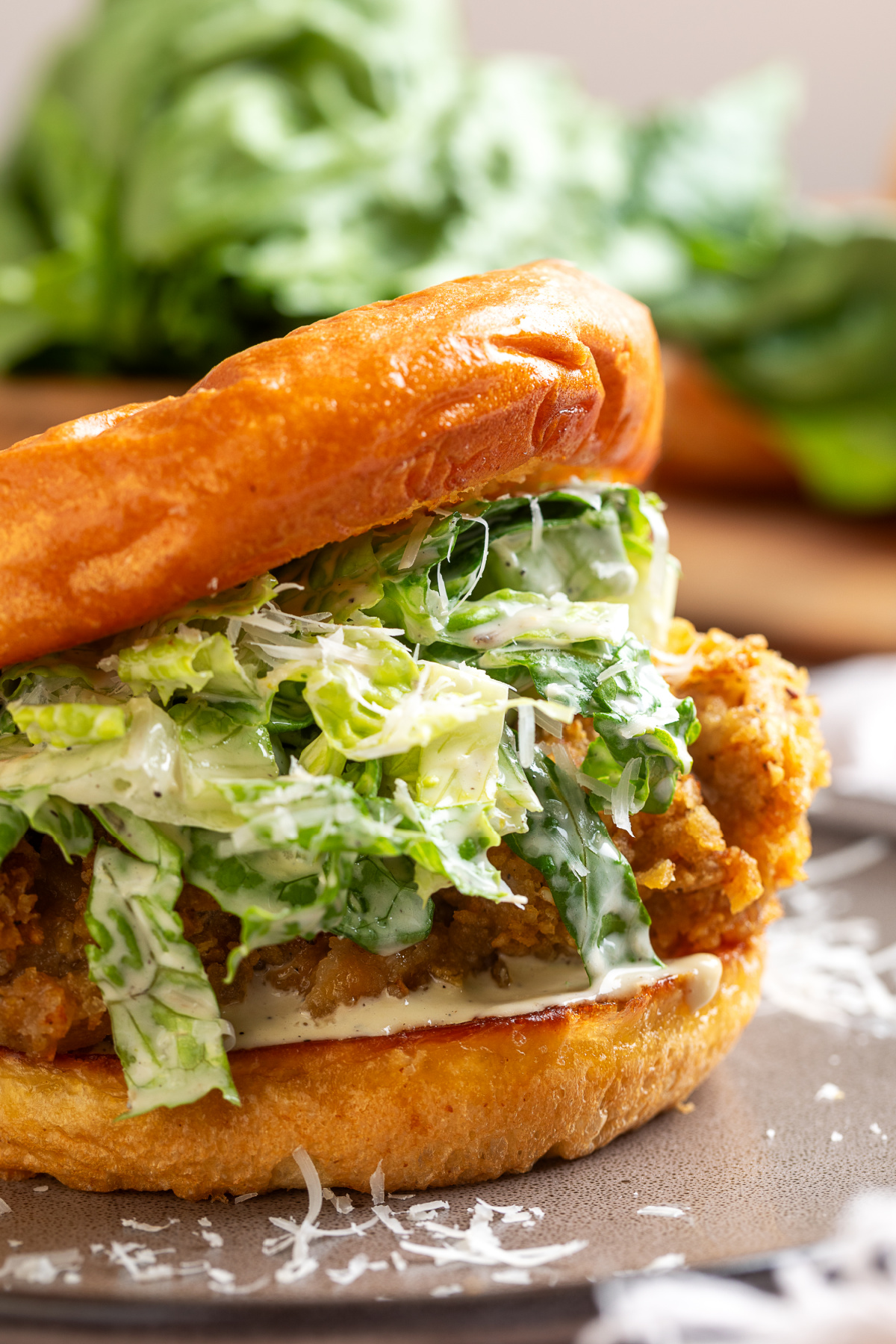 Chicken Caesar salad sandwich Chicken Caesar salad sandwich with crispy potato chip-crusted chicken, homemade Caesar salad, Parmesan cheese, and a toasted brioche bun.
