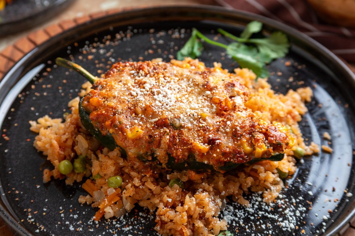 Chorizo and corn stuffed poblano pepper topped with melted cheese, Cotija and Taj&iacute;n