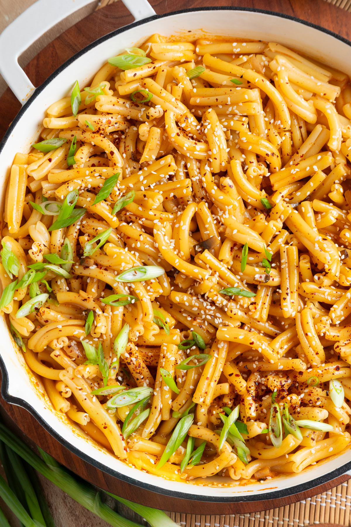 Casarecce pasta coated in creamy gochujang sauce with mushrooms, green onions and sesame seeds Creamy gochujang pasta with mushrooms, green onions, sesame seeds and gochugaru in a skillet