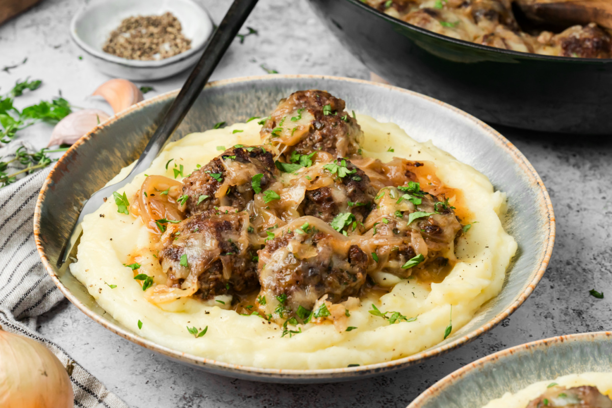 Beef meatballs with caramelized onion sauce, melted Gruyère and mashed potatoes. French onion meatballs in caramelized onion sauce served over mashed potatoes