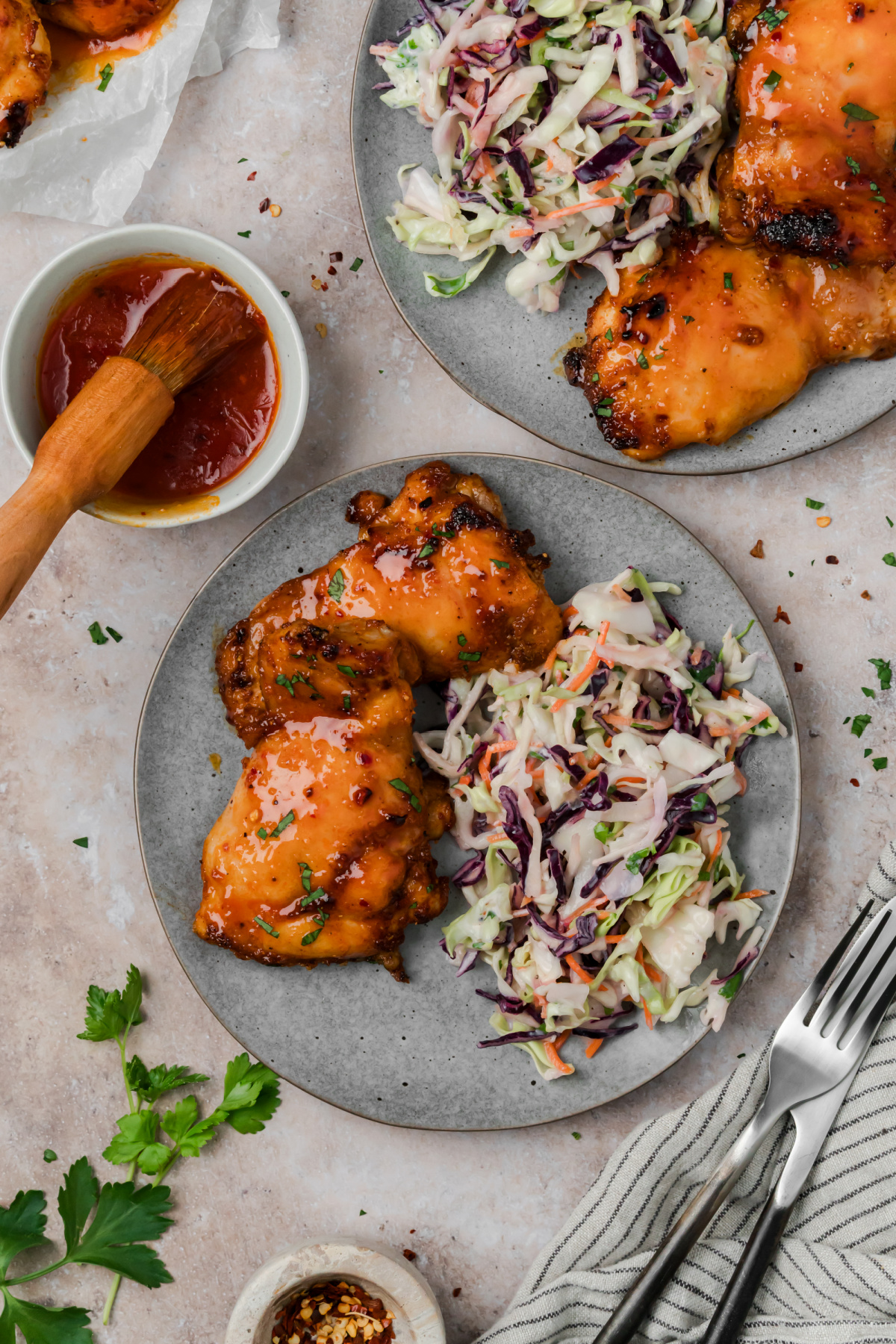 Hot honey chicken thighs served with creamy coleslaw and extra hot honey glaze on the side.