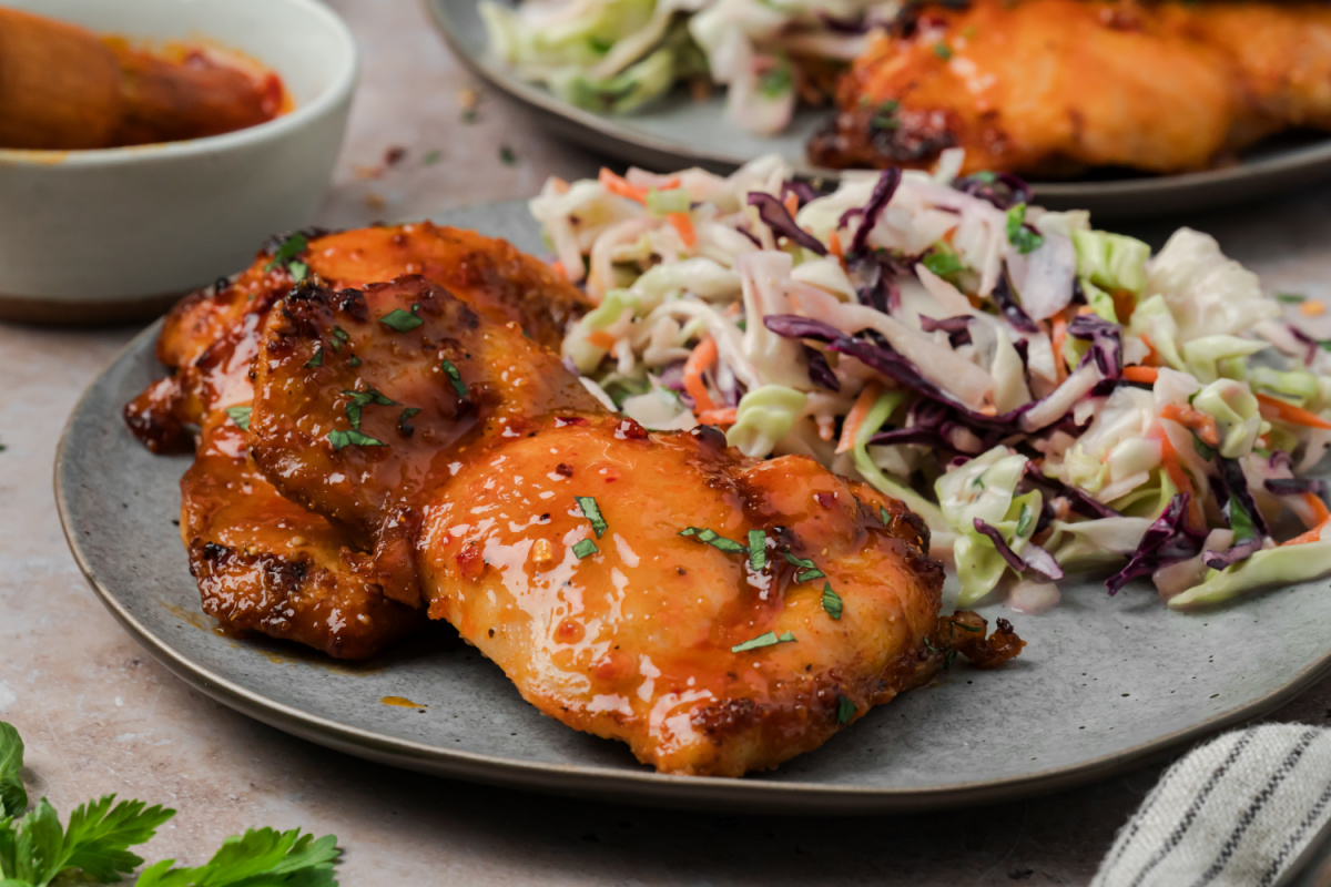Close-up of hot honey chicken thighs with caramelized homemade hot honey glaze.