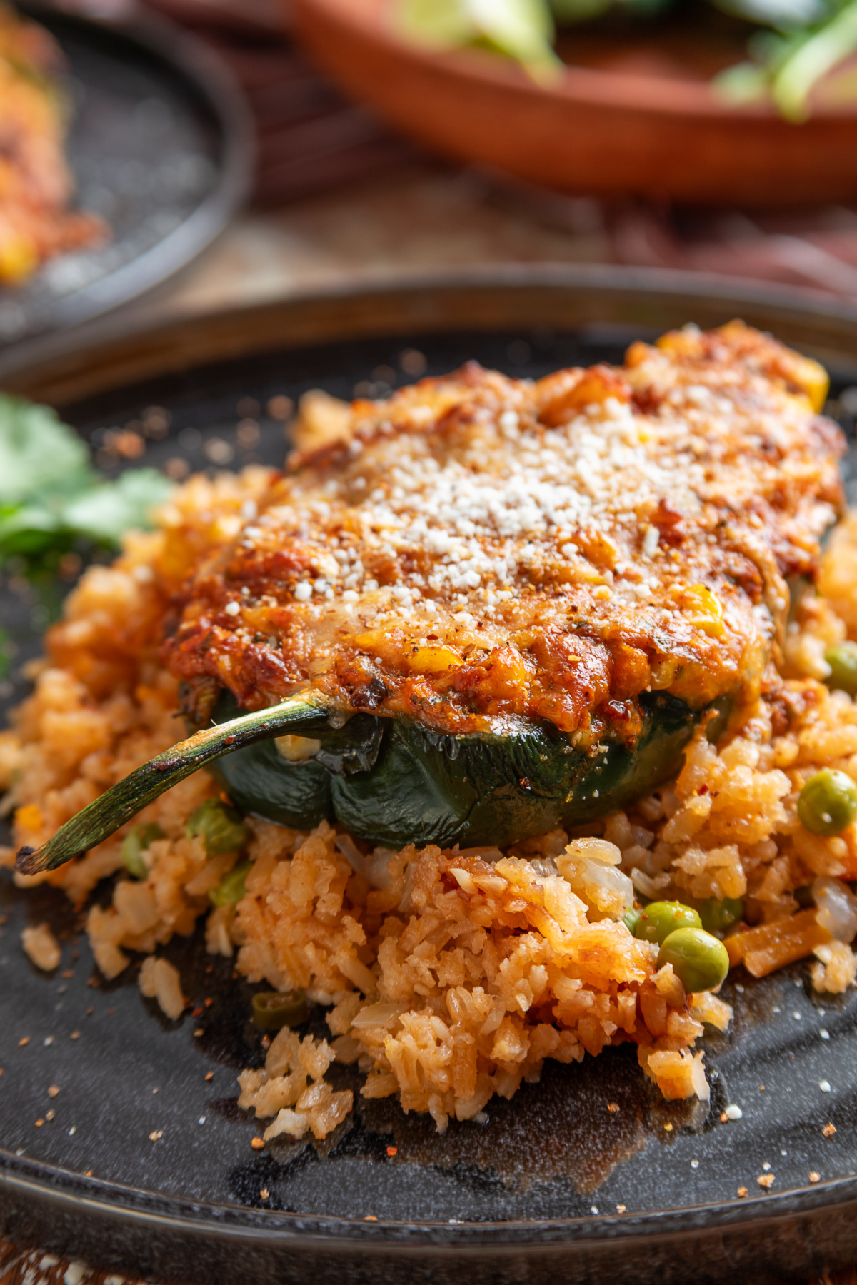 Mexican street corn stuffed poblano peppers with chorizo, corn, melted cheese, Cotija and Taj&iacute;n