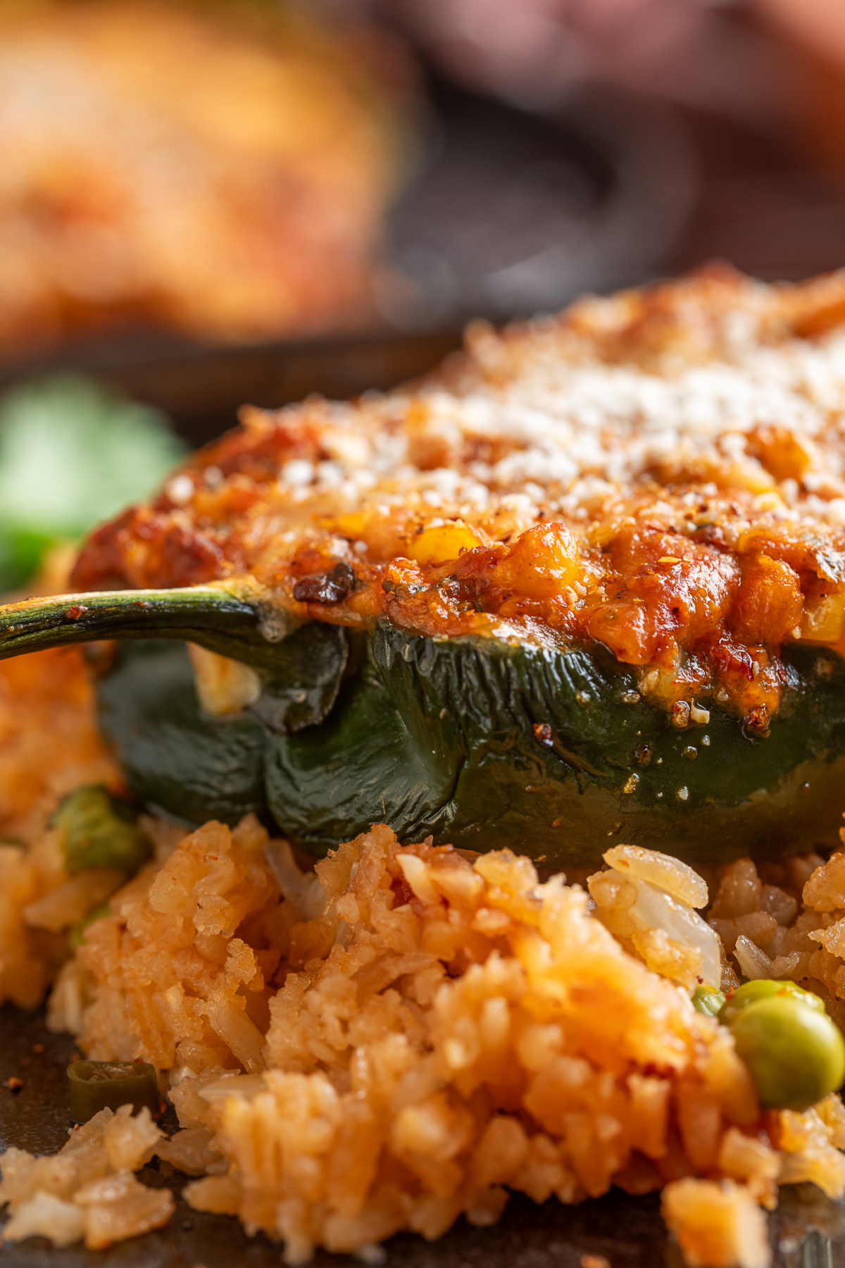 Close-up of a baked poblano pepper stuffed with corn, pork chorizo and melted cheese
