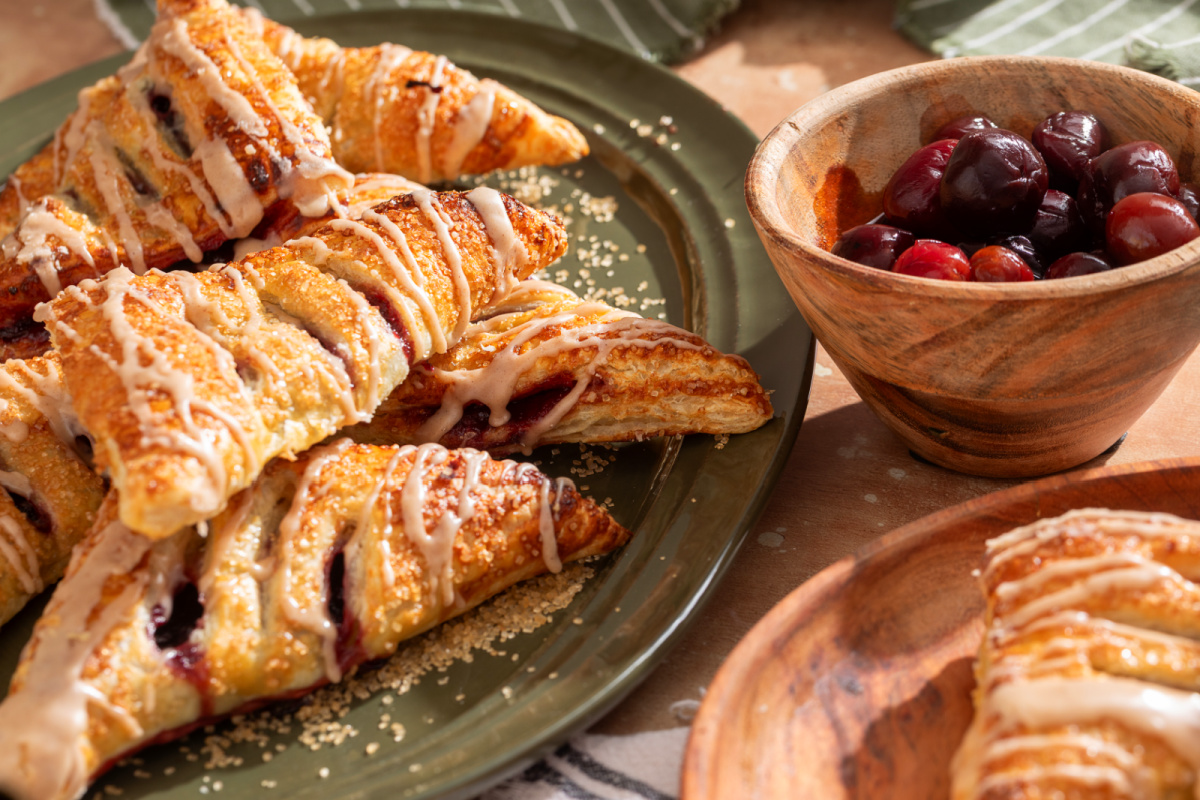 Bourbon glazed cherry turnovers served with dark cherries puff-pastry-cherry-turnovers-bourbon-glaze